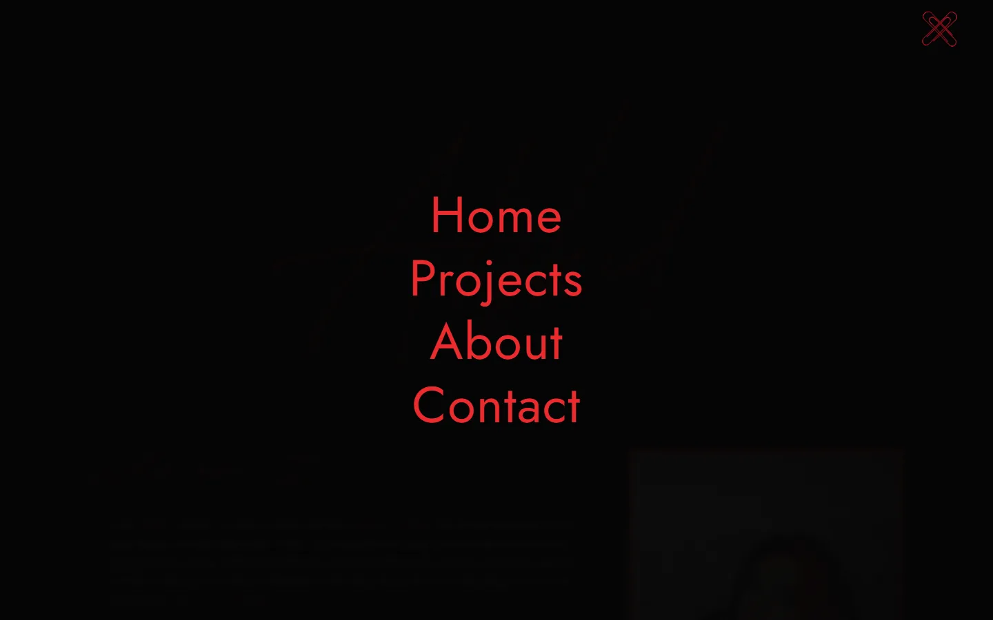 The full-screen menu: Home, Projects, About and Contact in large red type over the darkened page, with the two paperclips crossed into an X in the corner.